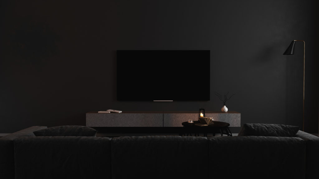Blank TV screen in modern dark interior with gray sofa in darkness mock up, front view. TV in living room interior background, empty TV display template, 3d render