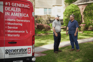 generac supercenter technician standing outside a service van talking with a happy customer
