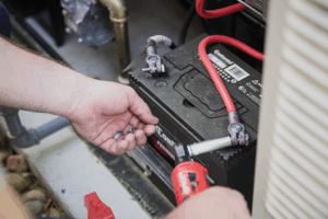 man's hand adjusting large battery