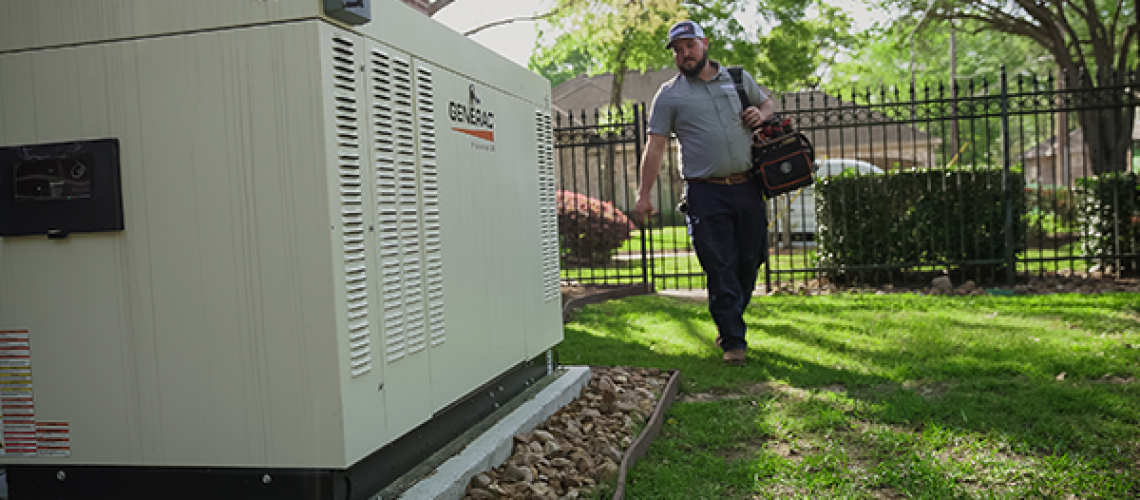 Generator Supercenter technician carrying a bag of tools and walking around a house towards a Generac generator for maintenance