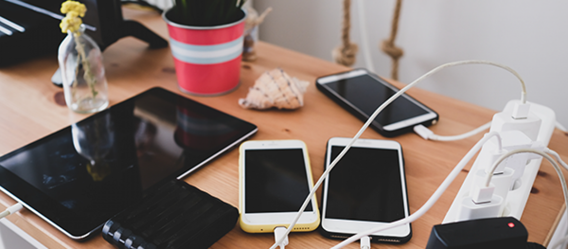 mobile phones and tablet plugged into power strip