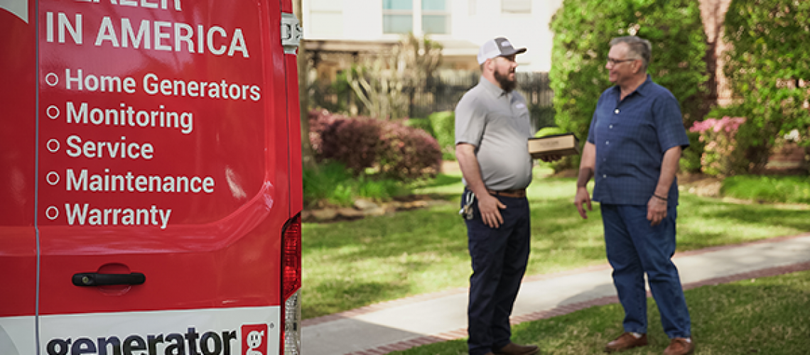 generator supercenter of st louis technician near a service vehicle speaking with a customer